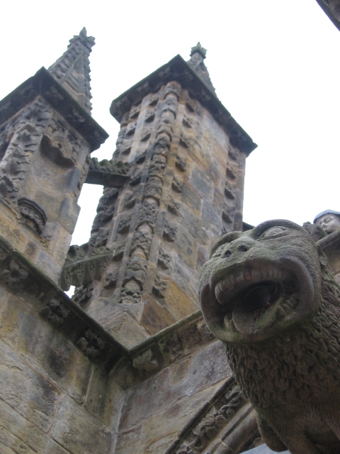 The gargoyles stuck out as strange monkey-lions. Behind is a buttress.